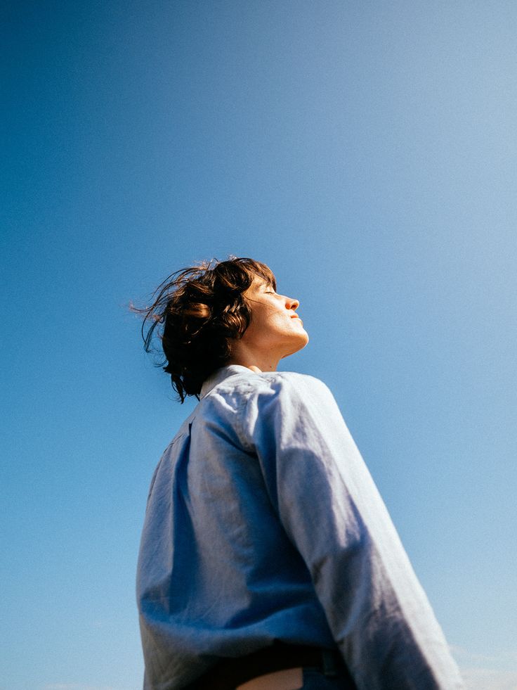 A person looking up at a clear blue sky